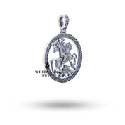 Side view of St George Pendant highlighting the circular shape and oxidized silver design.
