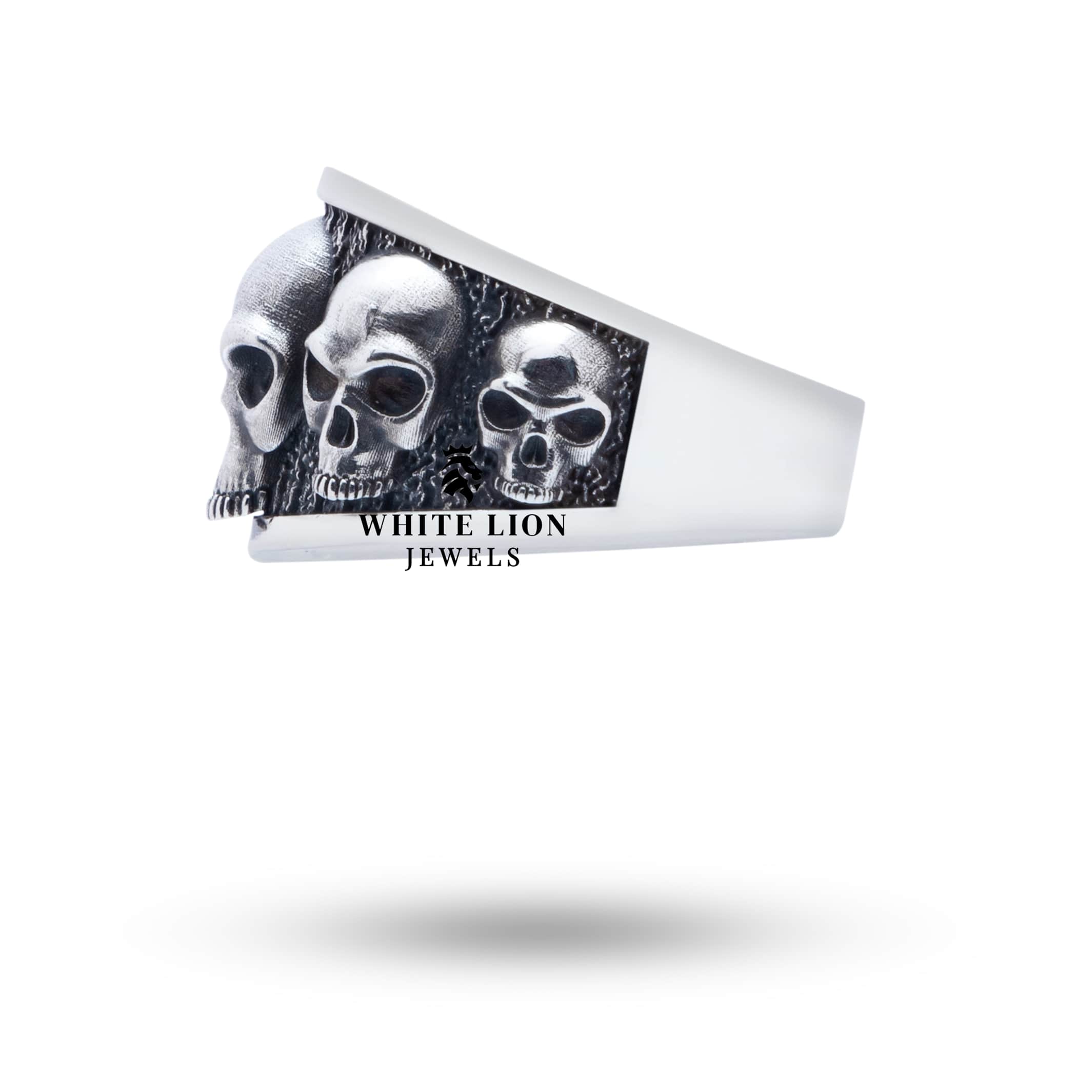 Angled view of Five Skulls 925 Sterling Silver Ring showcasing oxidized finish.