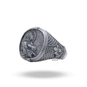 Close-up on the detailed craftsmanship of the Jesus Savior motif on the ring.