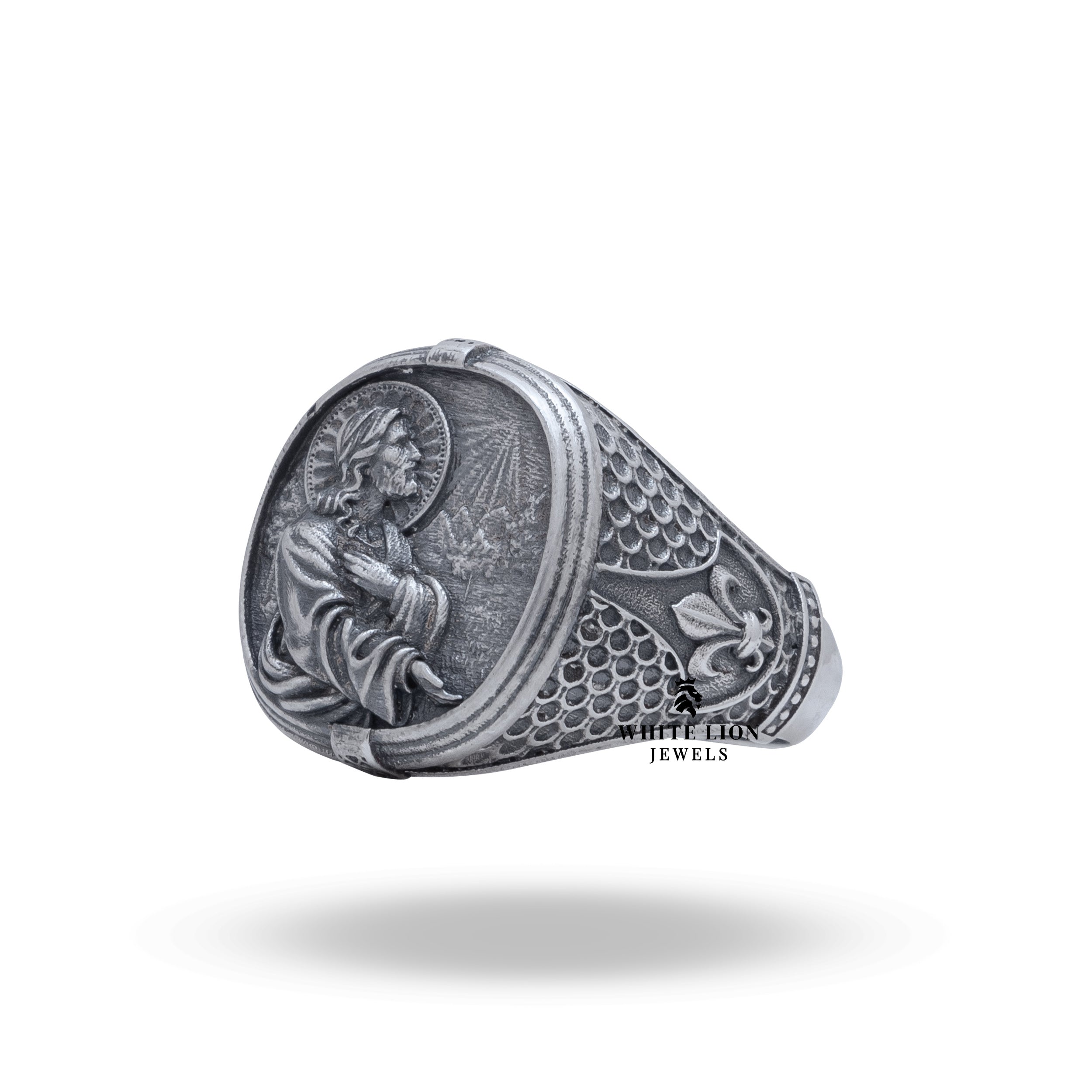 Close-up on the detailed craftsmanship of the Jesus Savior motif on the ring.