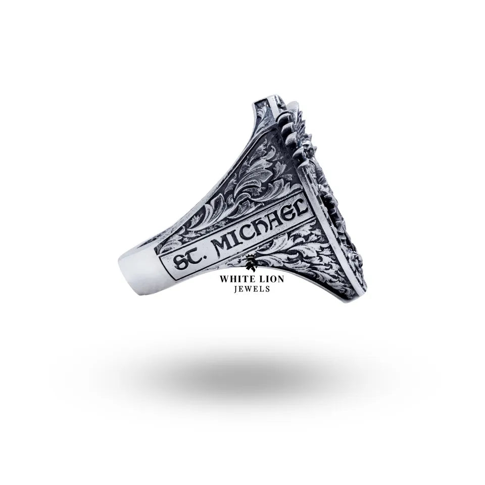 Angled view of St Michael 925 Sterling Silver Ring highlighting artistic engravings and polished finish