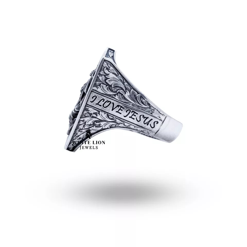 The Jesus Lord Savior silver ring worn on a hand, displaying its elegant design.
