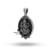 Close-up of intricate Lord Ganesha detailing on oval silver pendant.