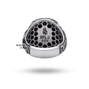 Styled image of lion themed oxidized silver ring in elegant setting.