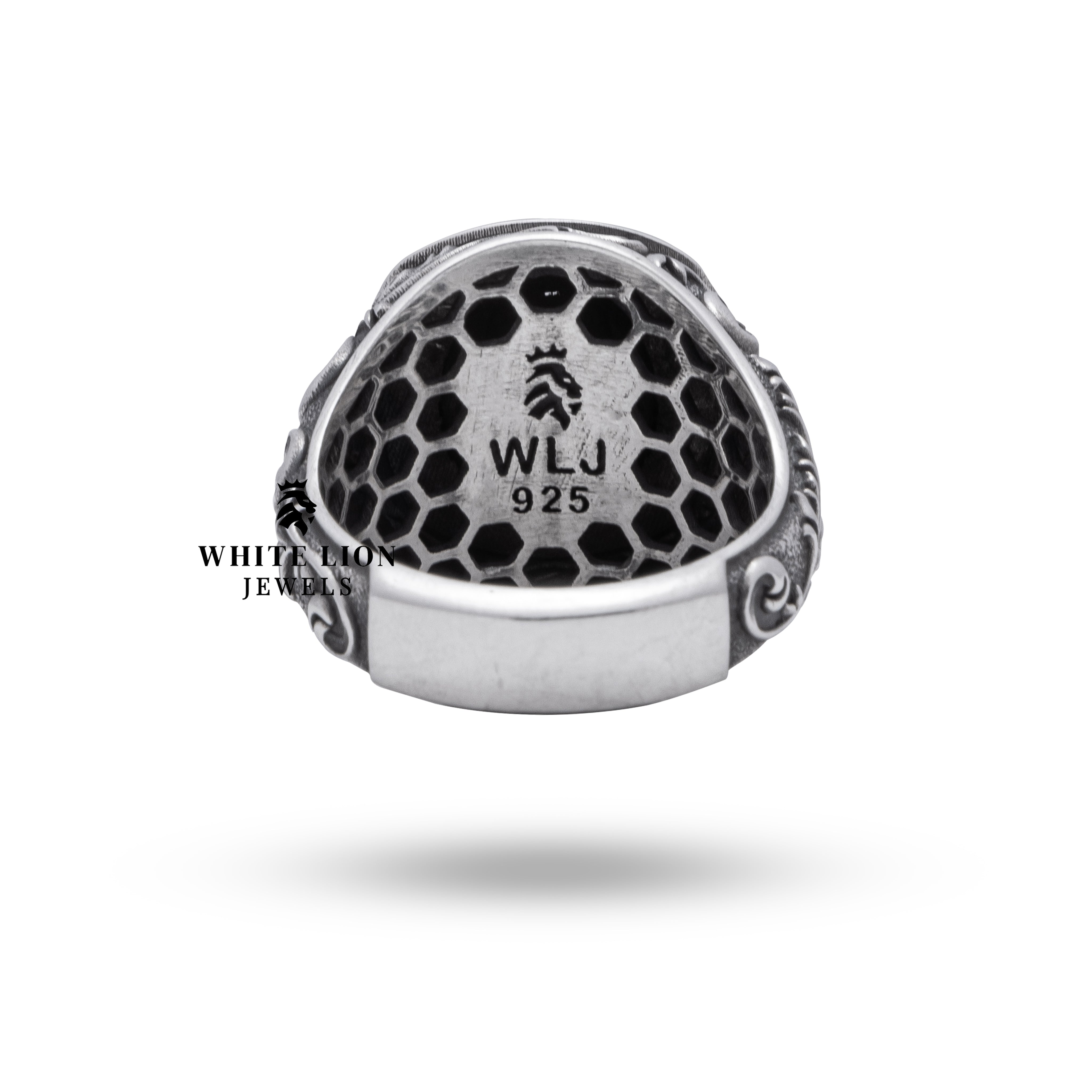 Styled image of lion themed oxidized silver ring in elegant setting.