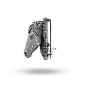 Image showing scale of the Horse Polo Jokey Race Brooch in hand against a monochrome background