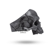 Side view of oxidized silver skull-themed ring with detailed craftsmanship