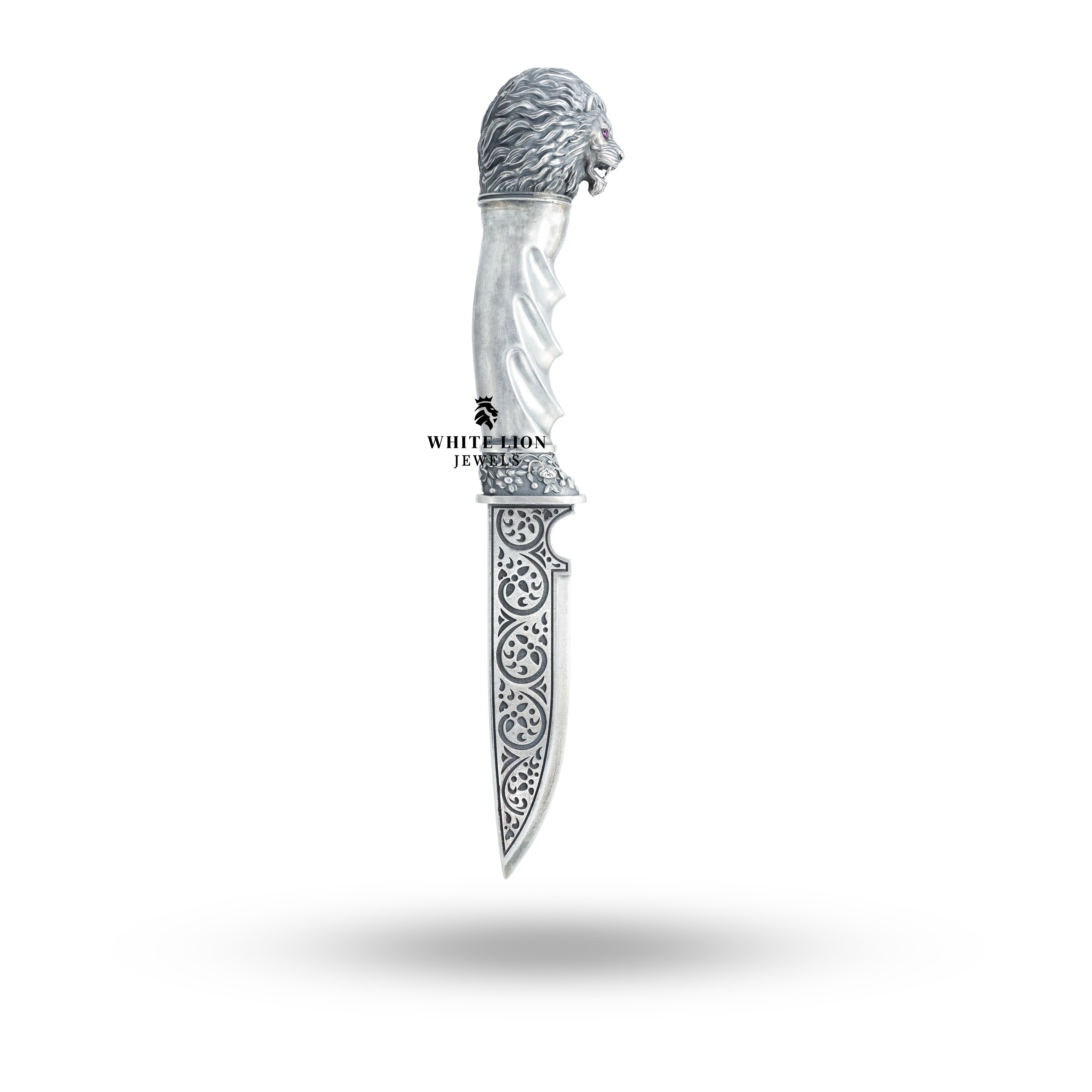 Angled view of the Lion Head Katar revealing its elegant oxidized silver finish.