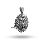 Side view showing the three-dimensional lion head sculpted on the pendant.