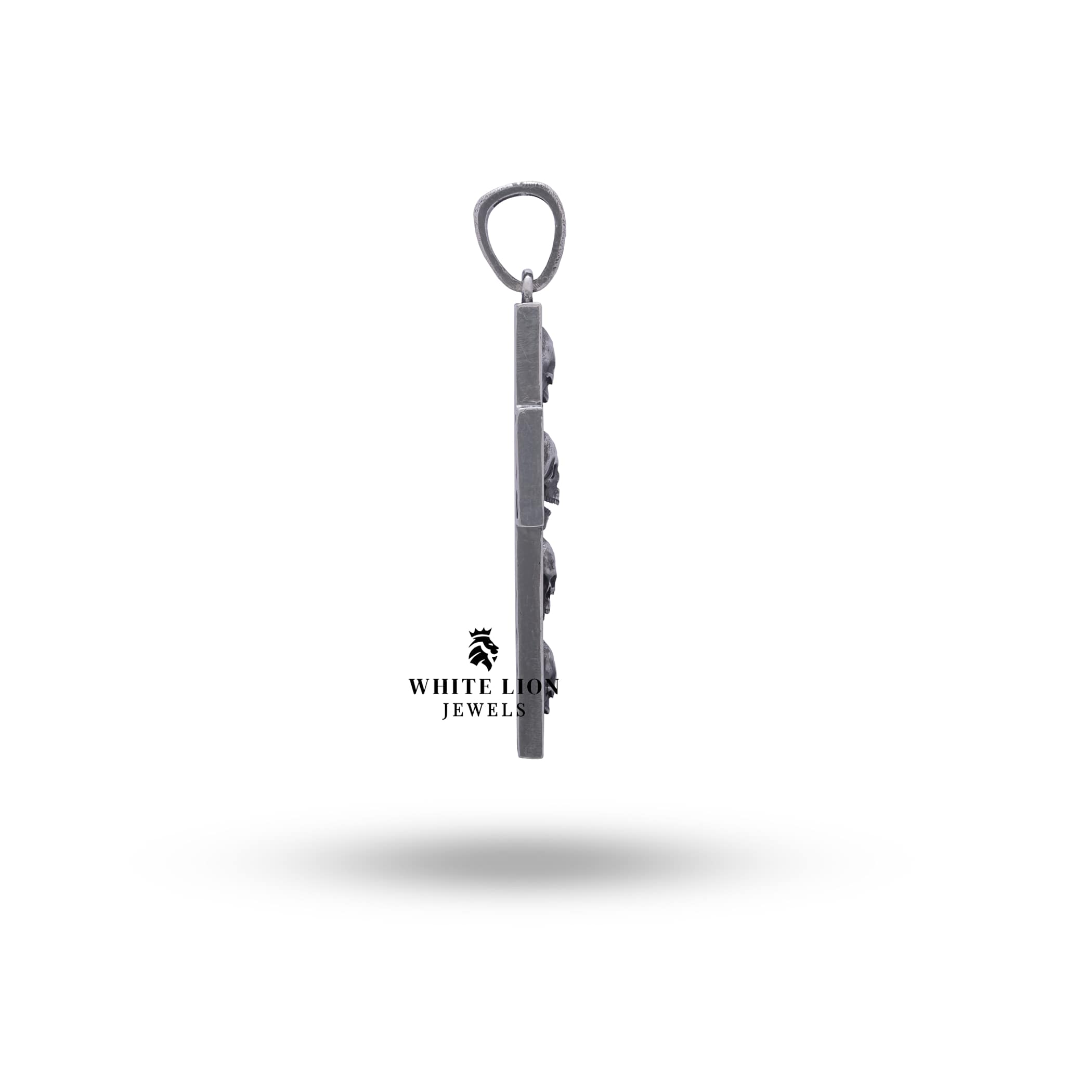 Close-up of oxidized silver cross from Open Jaw Skull Sterling Pendant, showing precision in details