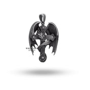 Side view of intricate sterling silver pendant featuring skull and dragon motifs