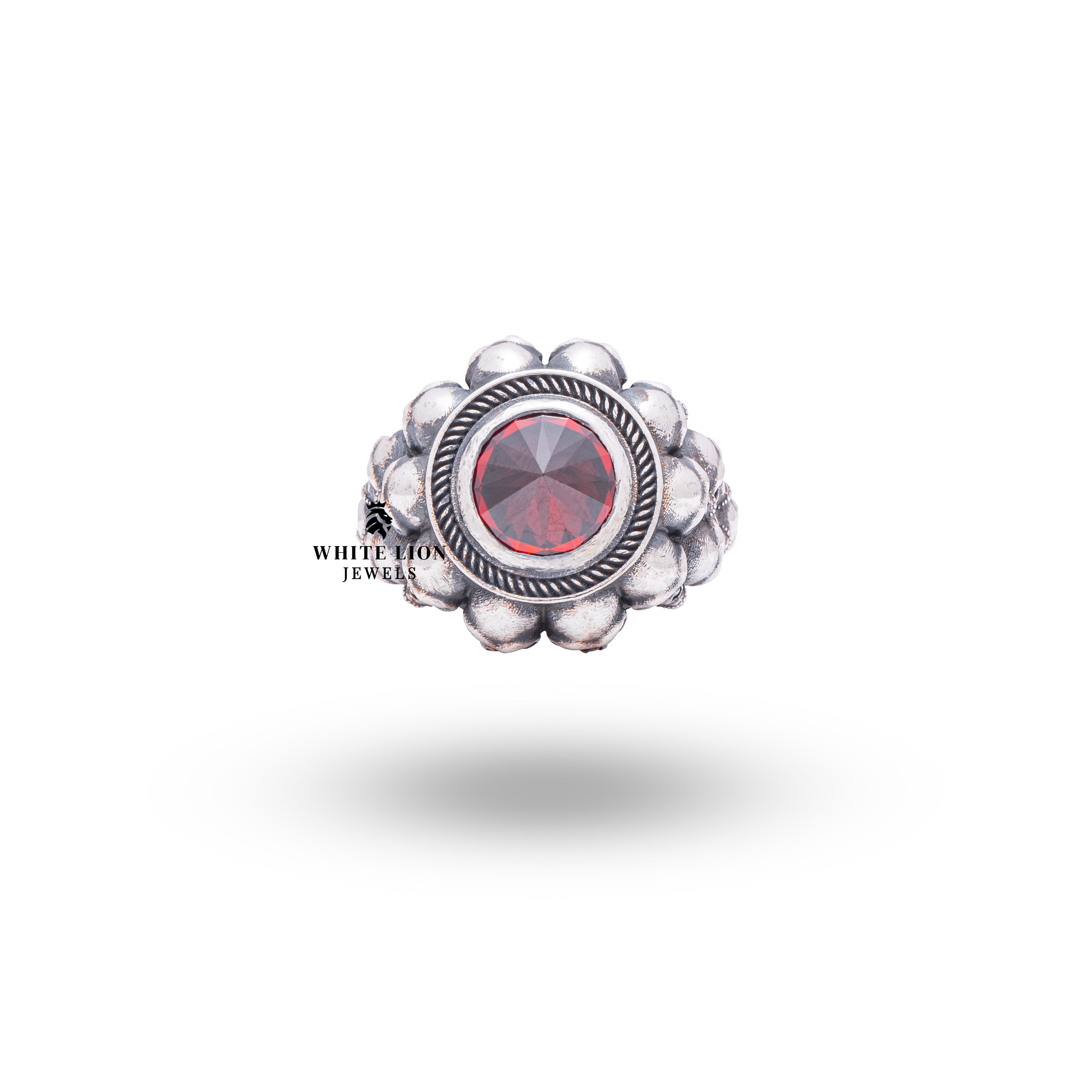 Artisan-crafted gothic ring with intricate skull details and deep red garnet from White Lion Jewels.