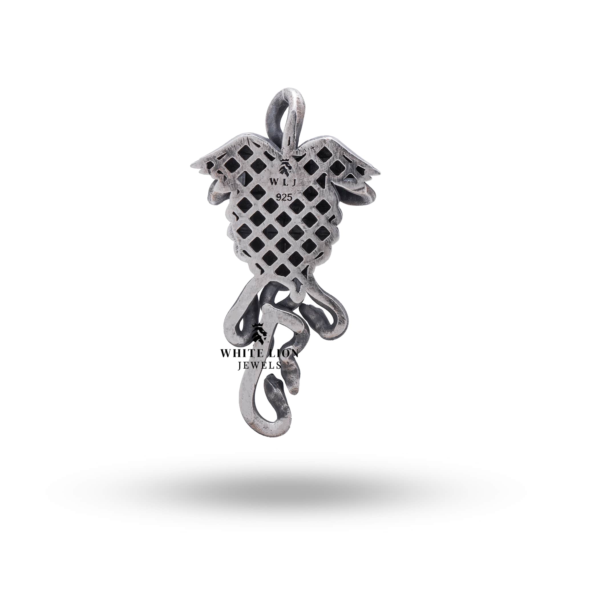 Close-up of Medusa and serpentine design on sterling silver pendant, highlighting detailed artistry and oxidized appearance.