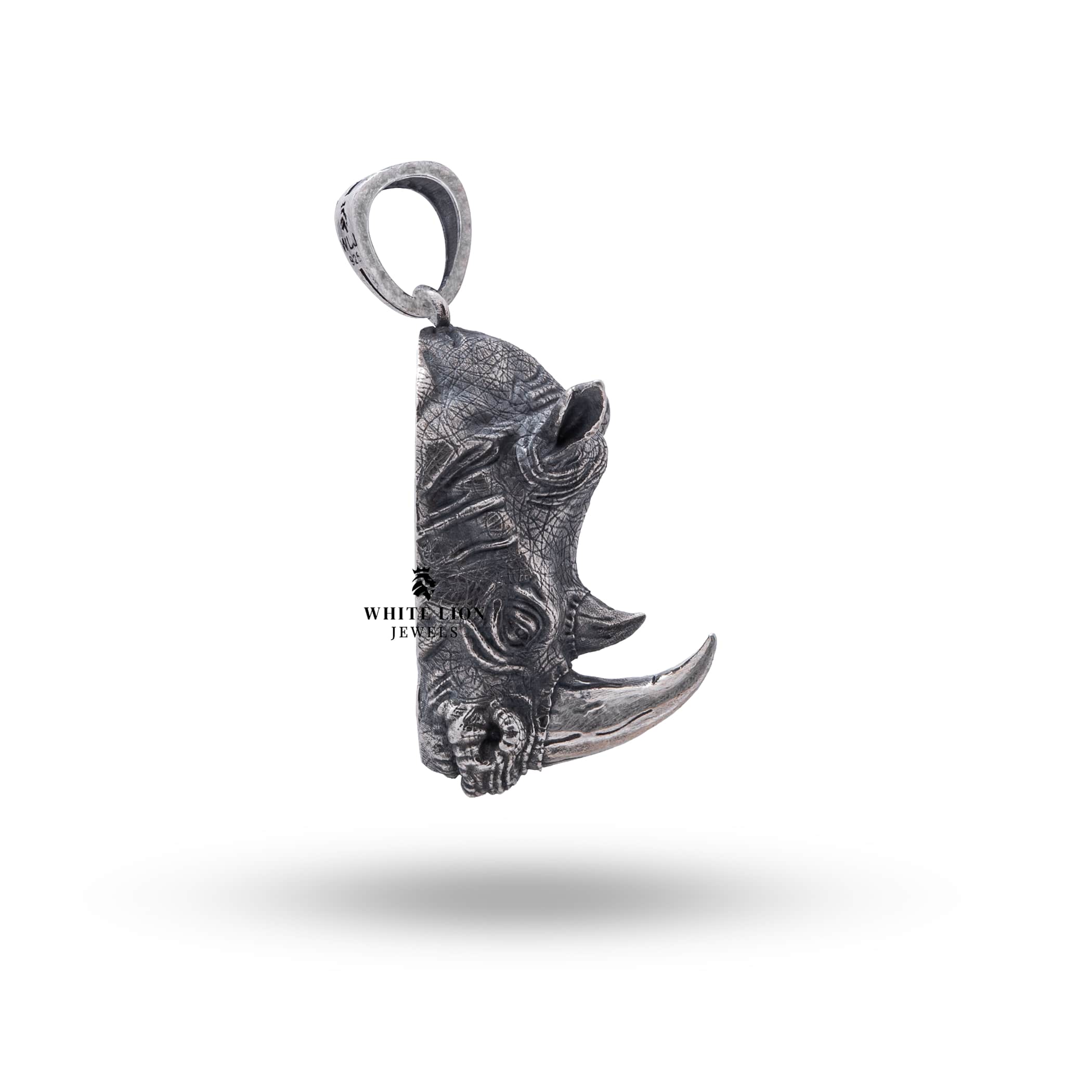 Rhino Head Silver Pendant placed in a natural setting