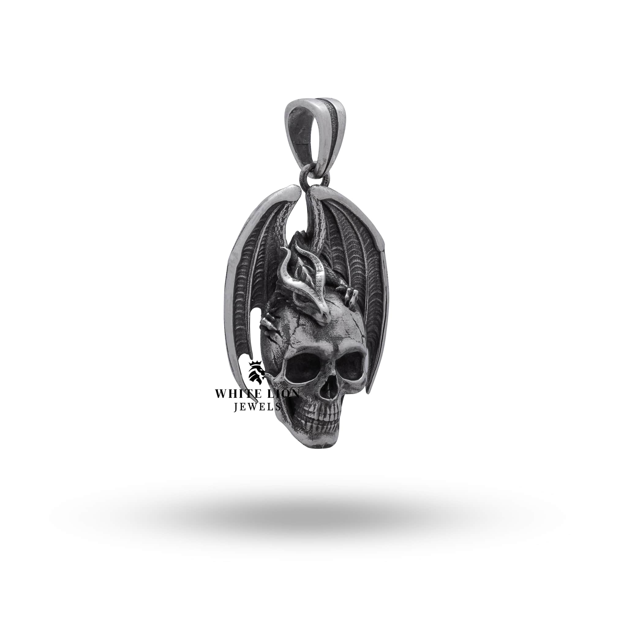 Close-up of dragon wings skull detailing in sterling silver pendant