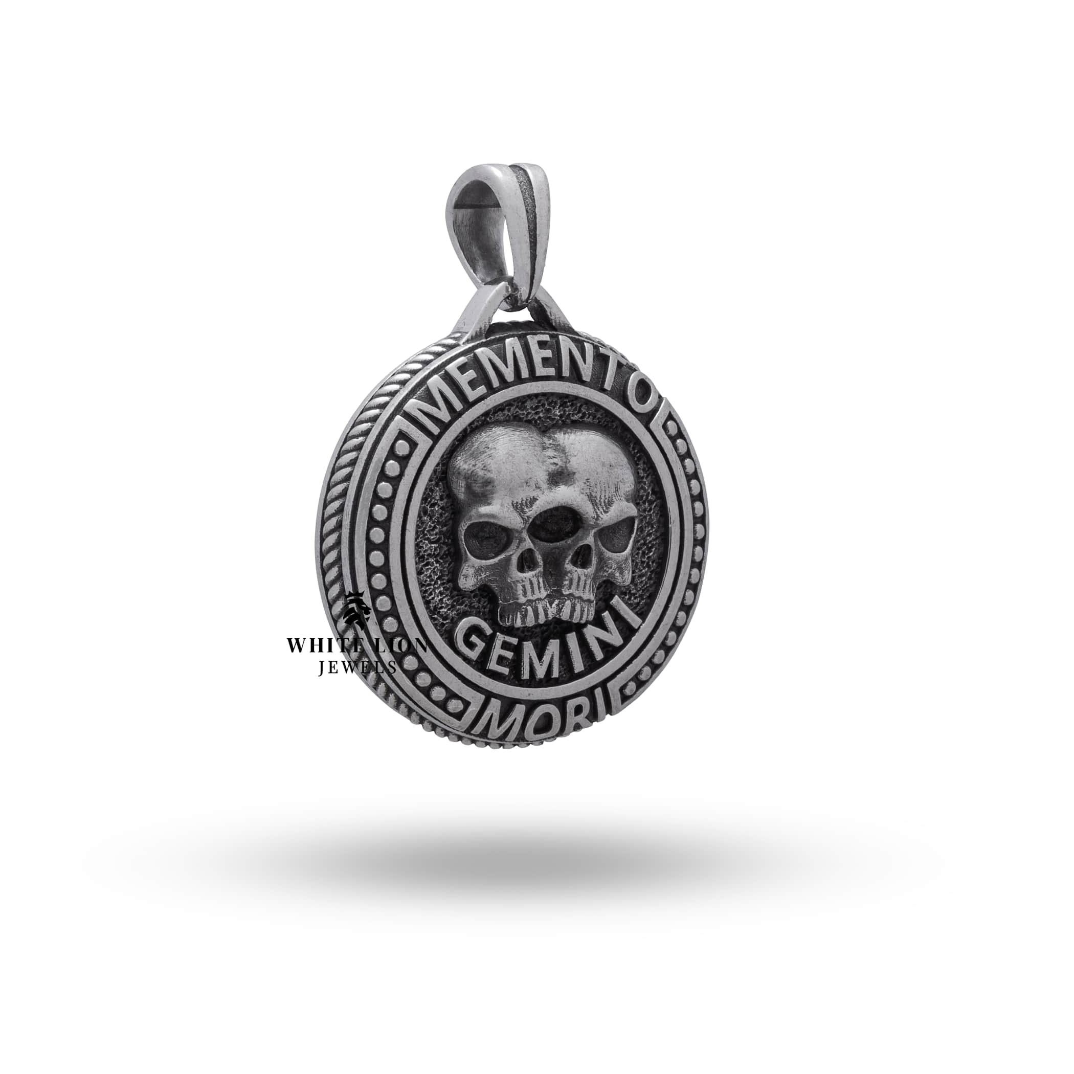 Close-up of the Gemini symbol on the oxidized silver pendant with intricate detailing.